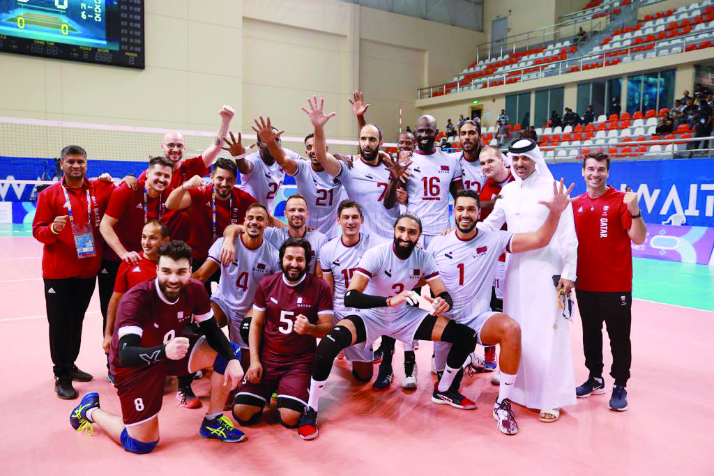 Qatar Volleyball Association President Ali bin Ghanem Al Kuwari celebrates with champion Al Annabi players and officials.