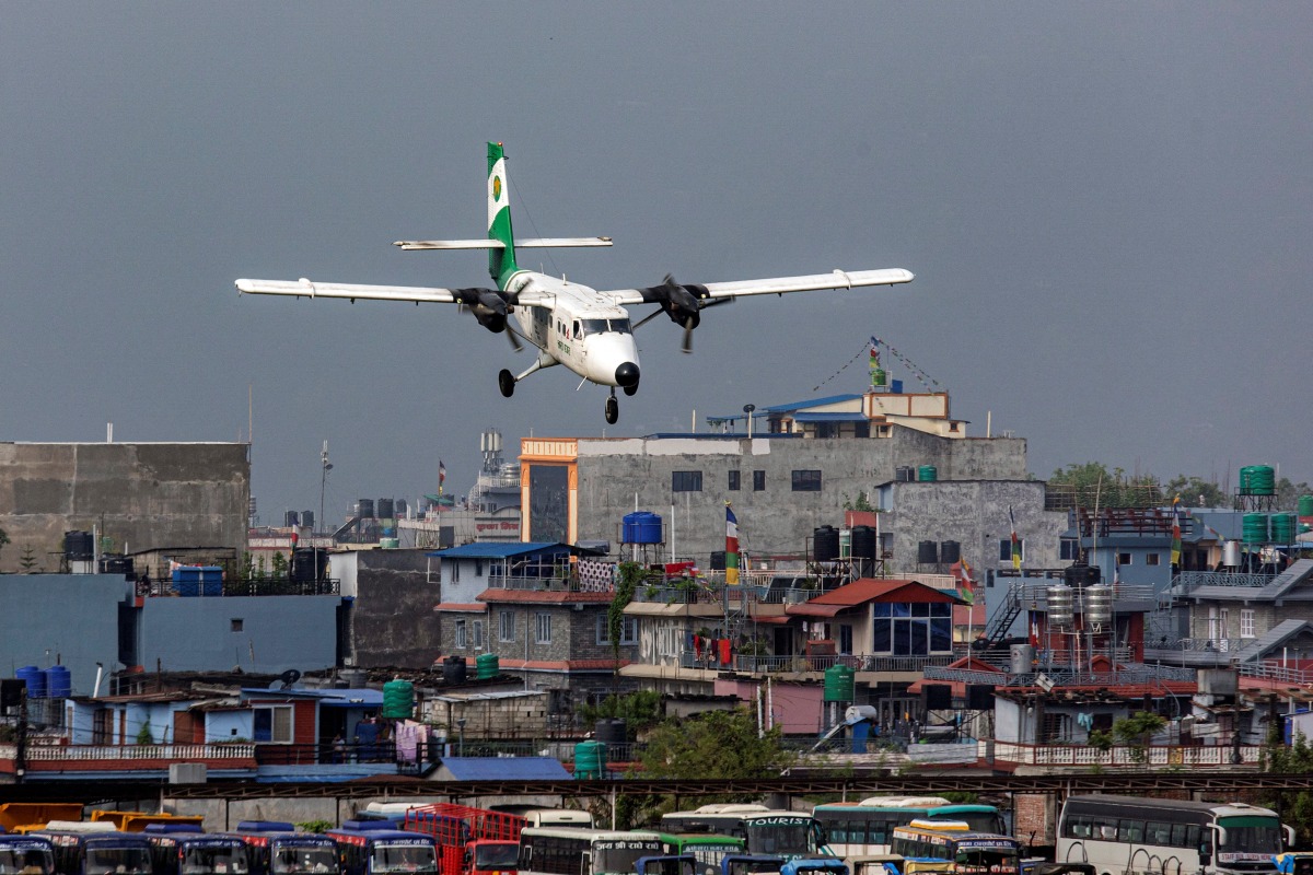 Tara Air's DHC-6 Twin Otter, tail number 9N-AET prepares to land at the airport of Pokhara, Nepal, April 11, 2022. Picture taken April 11, 2022. REUTERS/Nicolas Economou
