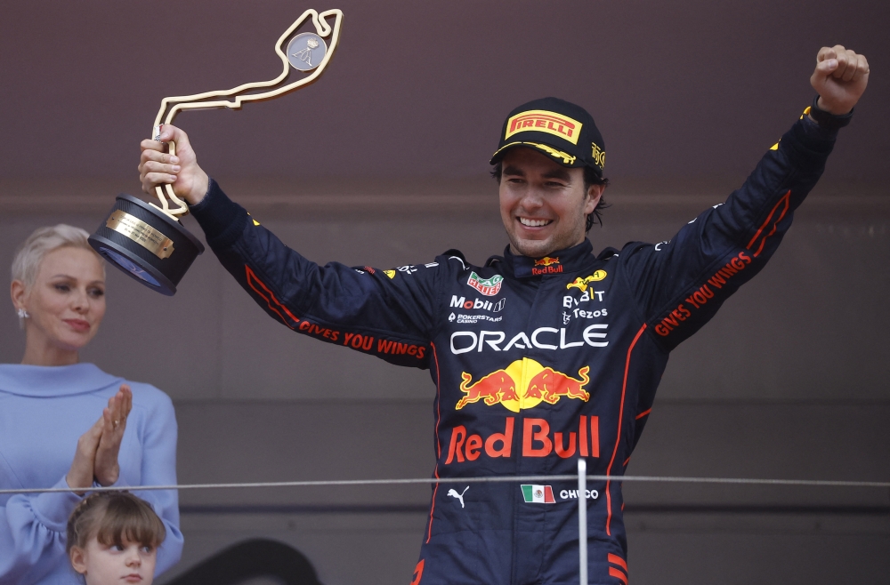 Red Bull's Sergio Perez celebrates with a trophy on the podium after winning the race as Princess Charlene of Monaco applauds REUTERS/Christian Hartmann
