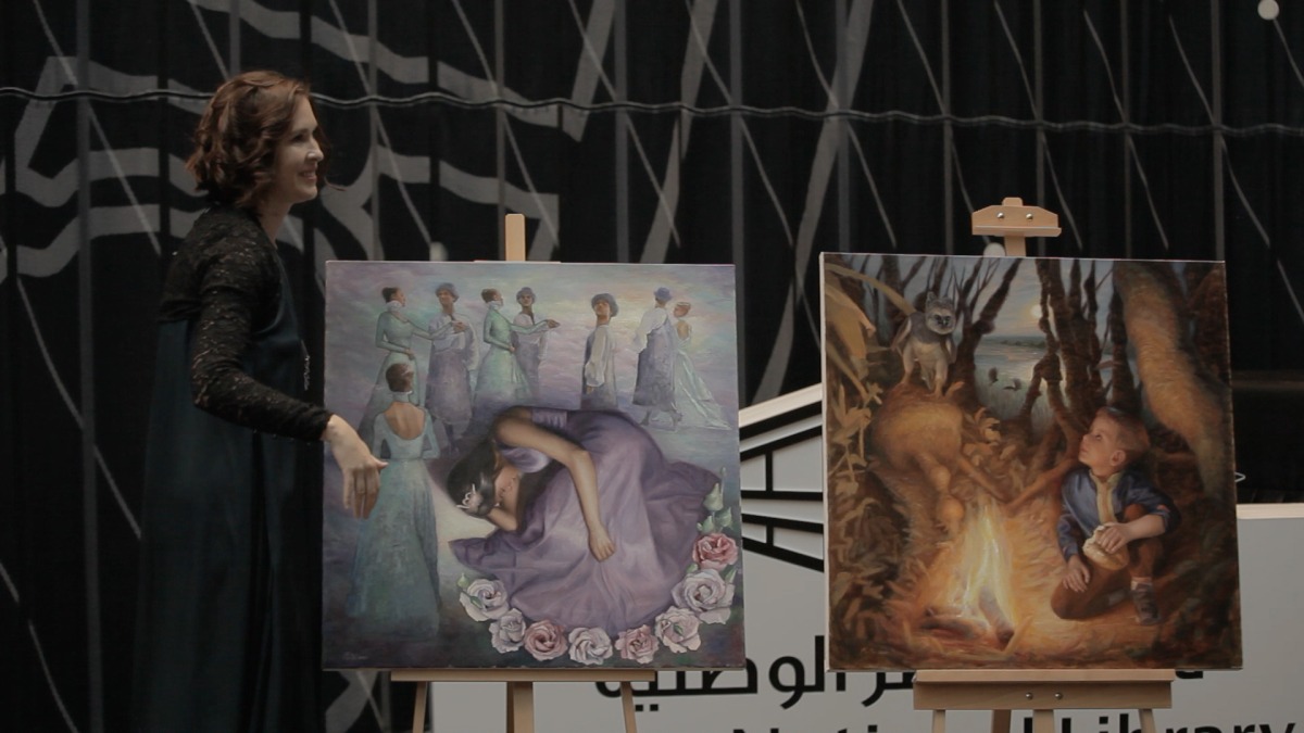 Mariya Medvedeva shows some of her artworks during the “Unravel” concert.