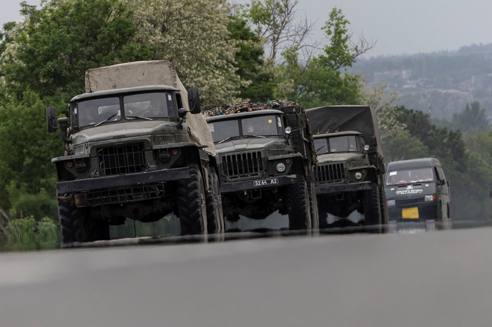 Military vehicles are see moving along a road, amid Russia's invasion of Ukraine, in the Donetsk region, Ukraine, May 31, 2022 REUTERS/Carlos Barria