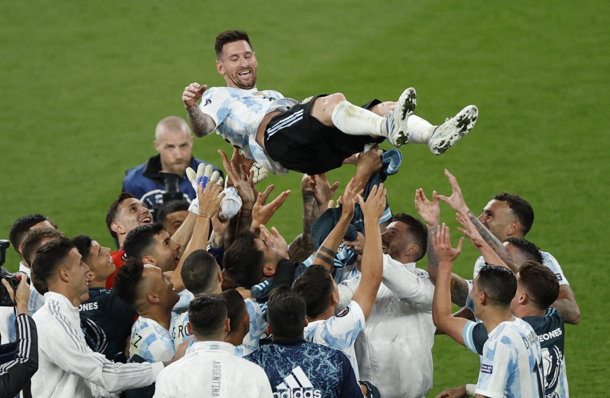 Argentina's Lionel Messi is toosed by with teammates REUTERS/John Sibley