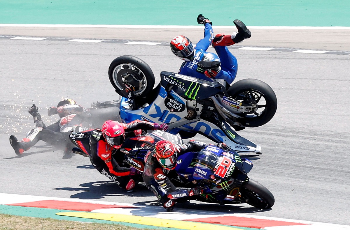 Team Suzuki Ecstar's Alex Rins crashes out at the start of the race REUTERS/Albert Gea TPX IMAGES OF THE DAY