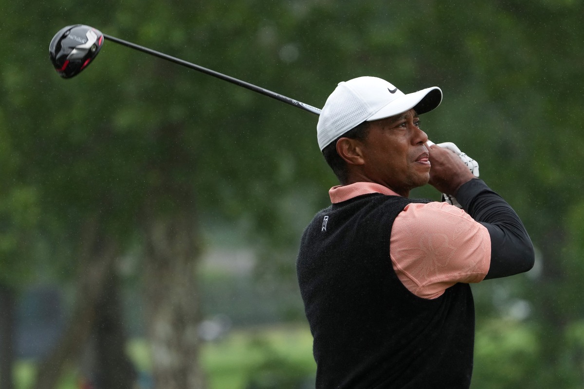 FILE PHOTO: Tiger Woods plays his shot from the ninth tee as rain falls during the third round of the PGA Championship golf tournament at Southern Hills Country Club. Mandatory Credit: Michael Madrid-USA TODAY Sports/File Photo
