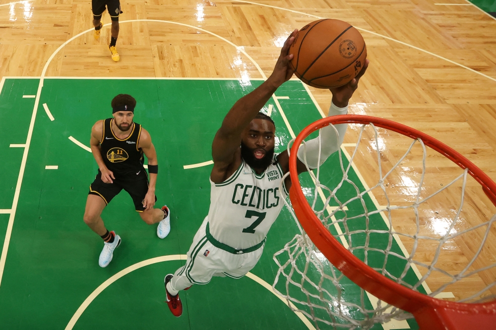 Boston Celtics guard Jaylen Brown (7) dunks and scores against the Golden State Warriors in the second half during game three of the 2022 NBA Finals at TD Garden.  Kyle Terada