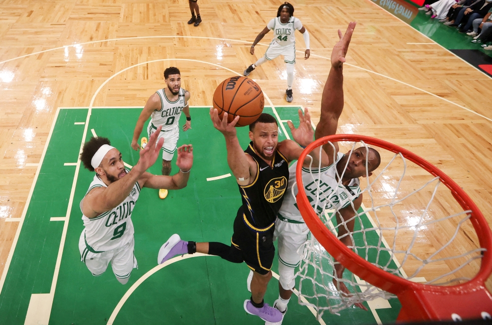 Golden State Warriors guard Stephen Curry (30) attempts a layup against Boston Celtics center Al Horford (42) during the first quarter of game four in the 2022 NBA Finals at the TD Garden.Elsa