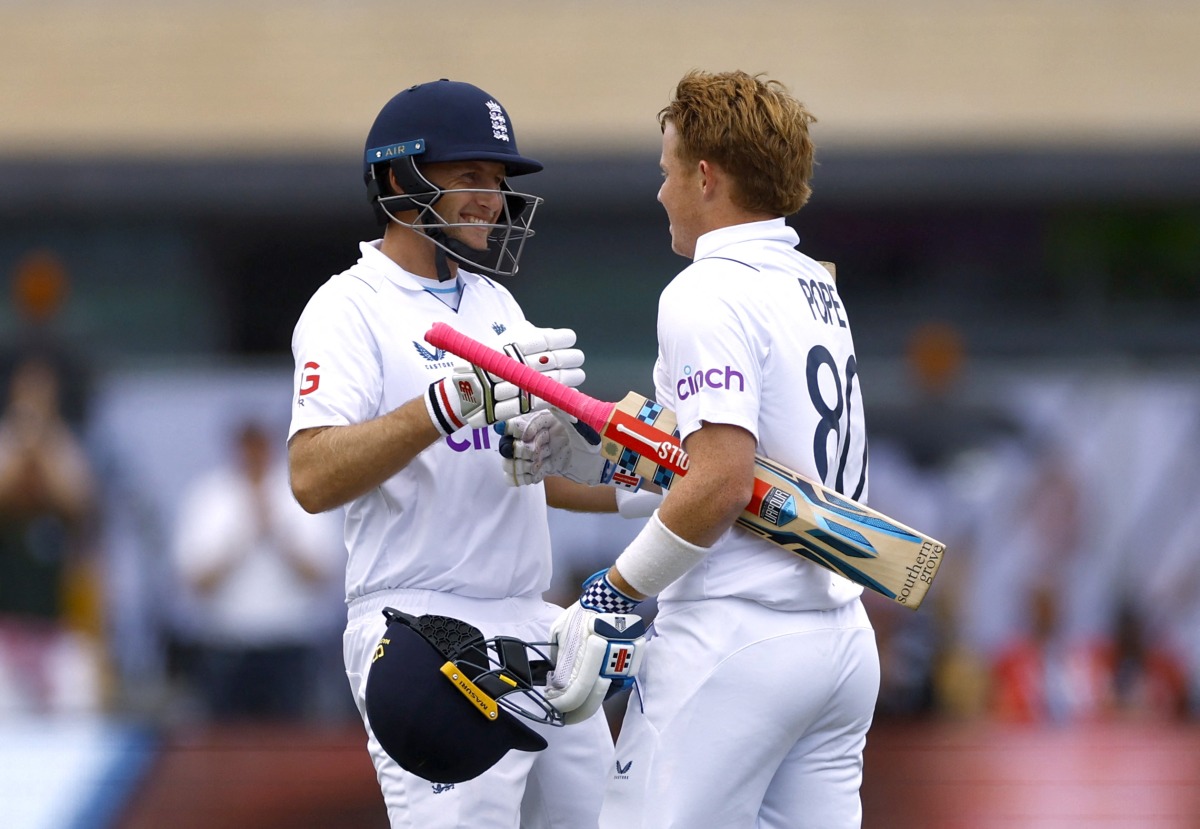 England's Ollie Pope celebrates reaching his century with Joe Root Action Images via Reuters/Andrew Boyers
