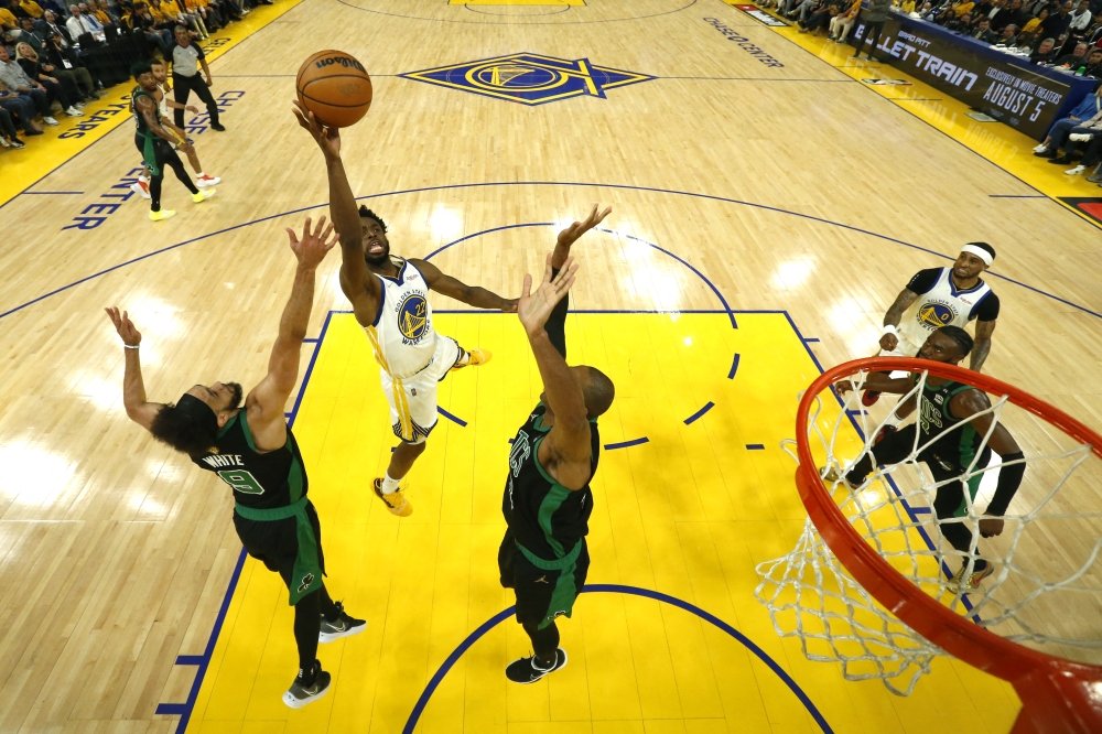 Golden State Warriors forward Andrew Wiggins (22) shoots the ball over Boston Celtics guard Derrick White (9) in game five of the 2022 NBA Finals at Chase Center. Jed Jacobsohn