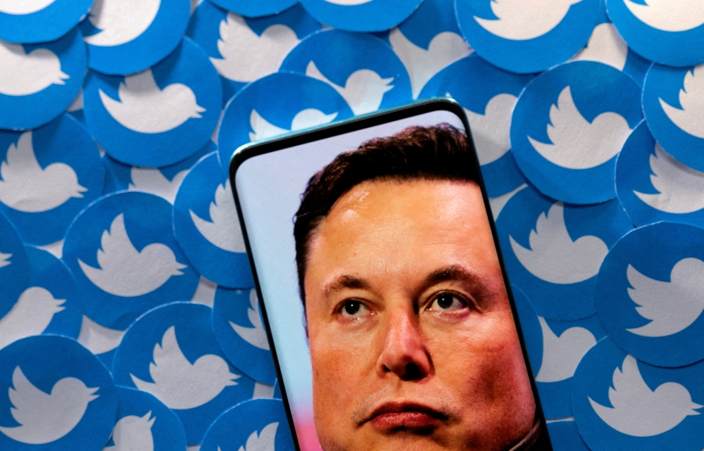 File photo: An image of Elon Musk is seen on smartphone placed on printed Twitter logos in this picture illustration taken April 28, 2022. Reuters/Dado Ruvic/Illustration/File Photo