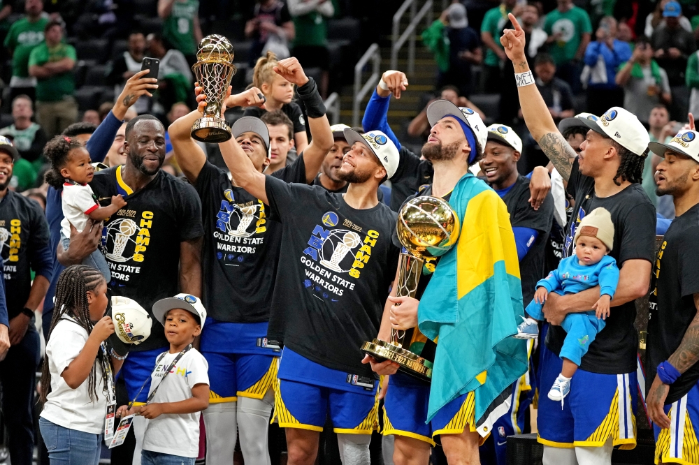 Golden State Warriors guard Stephen Curry (30) celebrates with the MVP trophy after the Golden State Warriors beat the Boston Celtics in game six of the 2022 NBA Finals to win the NBA Championship at TD Garden. Kyle Terada-USA TODAY Sports