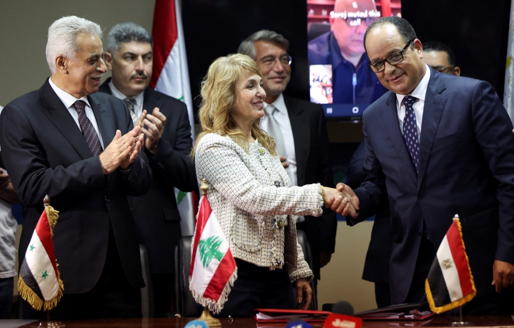 Director-General of Oil Facilities at Lebanese Energy Ministry Aurore Feghali shakes hands with Chairman of the Egyptian Natural Gas Holding Company (EGAS) Magdy Galal after they signed gas import agreement, at the energy ministry in Beirut, Lebanon June 21, 2022. REUTERS/Mohamed Azakir