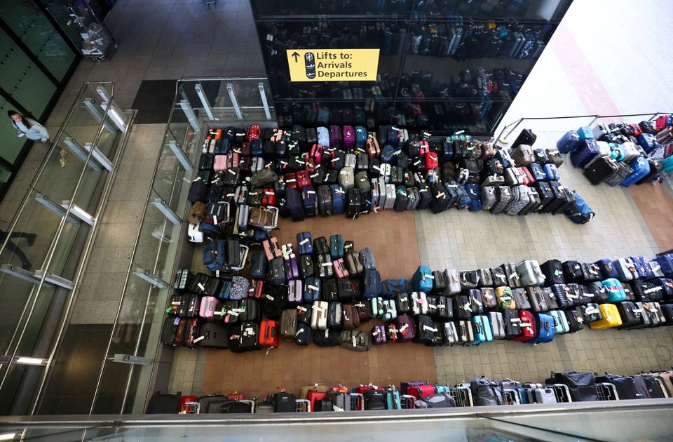 Lines of passenger luggage lie arranged outside Terminal 2 at Heathrow Airport in London, Britain, June 19, 2022. REUTERS/Henry Nicholls/File Photo

