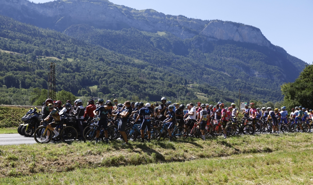 July 12, 2022 Riders wait after the race is neutralized due protestors blocking the route REUTERS/Gonzalo Fuentes