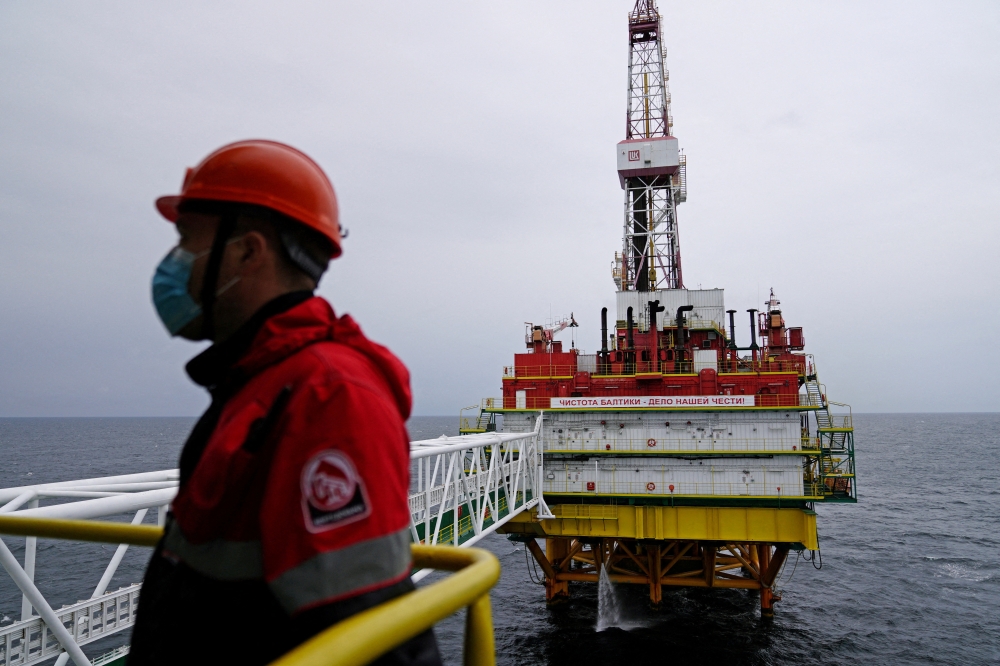 An employee is seen at an oil platform operated by Lukoil company at the Kravtsovskoye oilfield in the Baltic Sea. (REUTERS/Vitaly Nevar/File Photo)