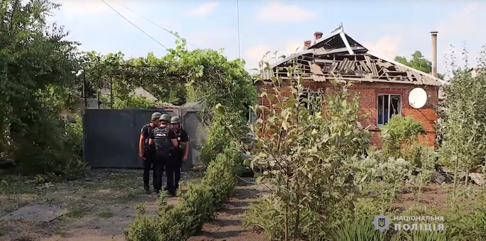 Police officers gather in front of a house damaged after a missile strike, amid Russia's invasion of Ukraine, in Pokrovsk, Donetsk region, Ukraine in this screen grab taken from a handout video released July 16, 2022. State National Police of Ukraine/Handout via REUTERS