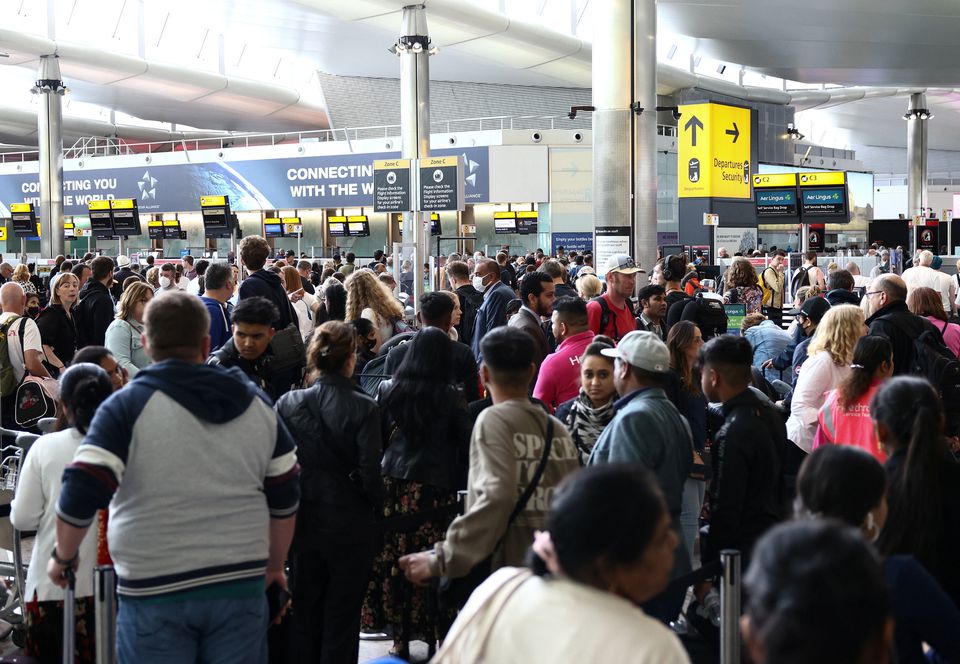 Passengers queue inside the departures terminal of Terminal 2 at Heathrow Airport in London, Britain, June 27, 2022. REUTERS/Henry Nicholls


