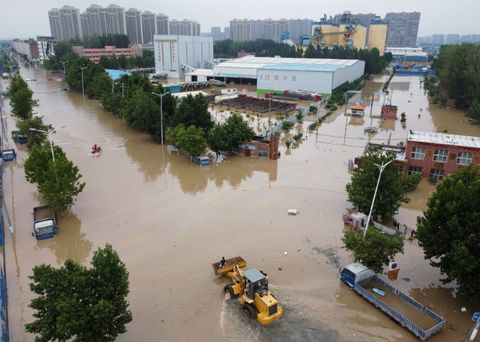 An aerial view shows rescue workers evacuating residents on a flooded road following heavy rainfall in Zhengzhou, Henan province, China July 22, 2021. Picture taken with a drone. REUTERS/Aly Song/File Photo