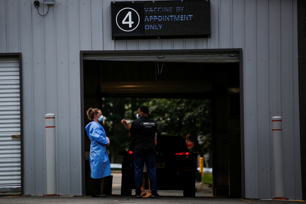 Staff members of the Westchester Medical Center await the arrival of people to be vaccinated with monkeypox vaccine in a drive-through point at the Westchester Medical Center in Valhalla, New York, U.S., July 28, 2022. REUTERS/Eduardo Munoz