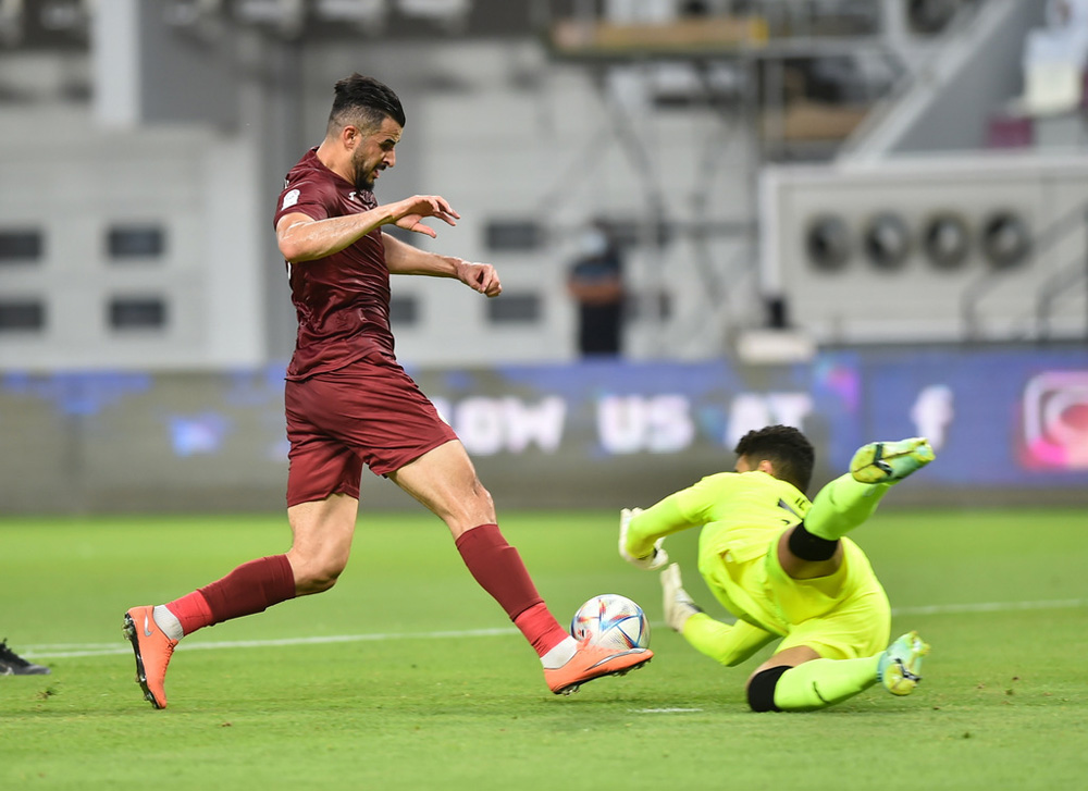 Al Markhiya's Aymen Hussein attempts to score as Al Sadd goalkeeper Jehad Mohammad dives during their opening match of the QNB Stars League, played at the Khalifa International Stadium, yesterday. Picture: Abdul Basit