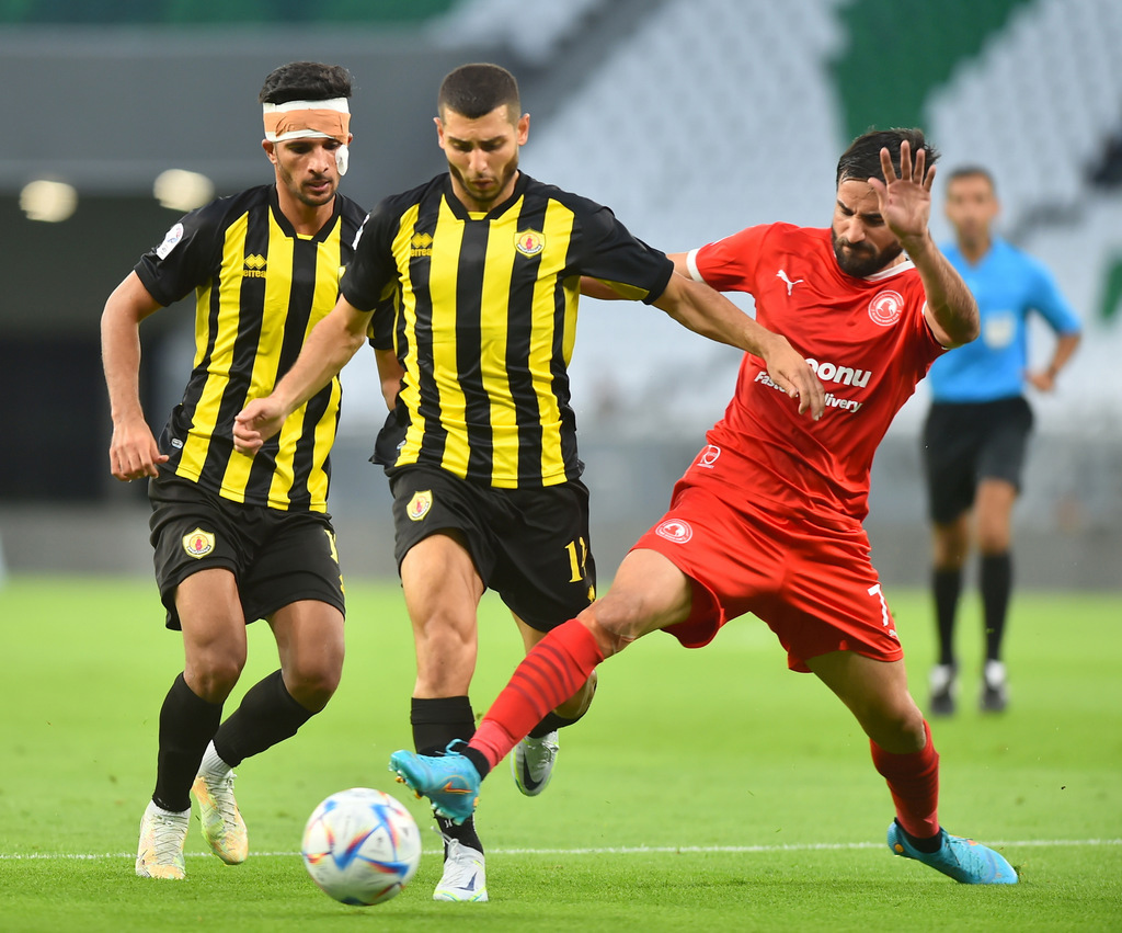 Al Arabi's Mehrdad Mohammdi Keshrazi vies for the ball with Qatar SC players. Pic: Abdul Basit