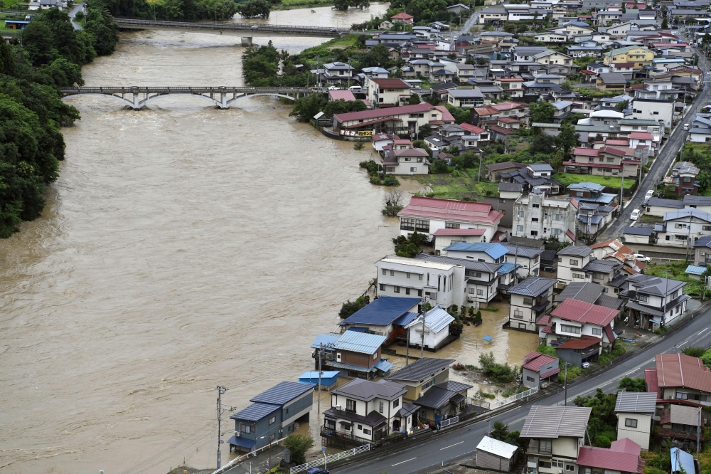 A view shows a submerged residential area caused by a flood of the Mogami river, in Oe town, Yamagata prefecture, Japan August 4, 2022, in this photo taken by Kyodo Mandatory credit Kyodo via REUTERS