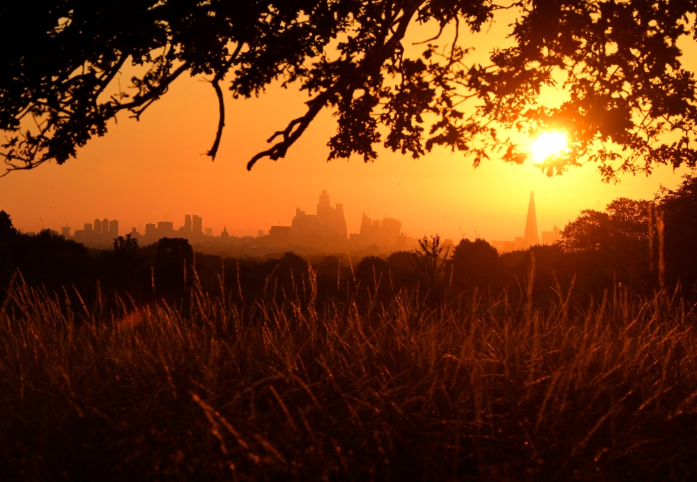 The sun rises above the London skyline, as a second heatwave is predicted for parts of the country, in London, Britain, August 11, 2022. REUTERS/Toby Melville