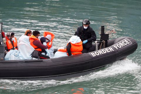 Border Patrol agents bring migrants into Dover harbour on a boat, after they tried to cross the channel, in Dover, Britain, September 7, 2020. REUTERS/Matthew Childs/File Photo