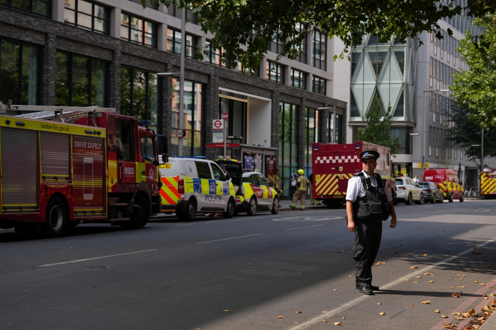 A police officer stands guard after closing the area near Waterloo due to a fire, in London, Britain, August 17, 2022. REUTERS/Maja Smiejkowska
