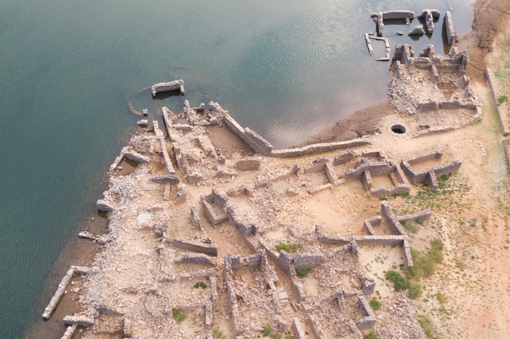 Aerial view of a previously submerged village revealed by low water levels in Cabril dam reservoir in Pedrogao Grande, Portugal, July 13, 2022. REUTERS/Miguel Pereira/File Photo