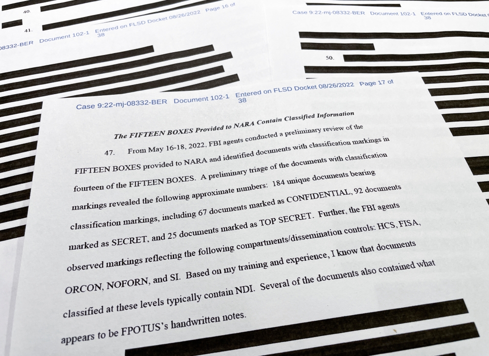 The 17th page of the redacted version of an affidavit that the US Justice Department submitted to a federal judge to support the execution of a search warrant by the FBI at former President Donald Trump's Mar-a-Lago estate shows a list of the classification markings found on documents returned in 15 boxes to the National Archives by Trump including 