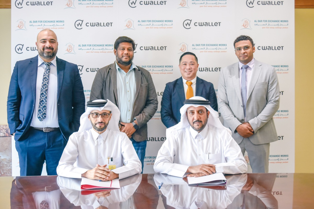 Officials from CWallet and Al Dar For Exchange Works during the agreement signing ceremony. 