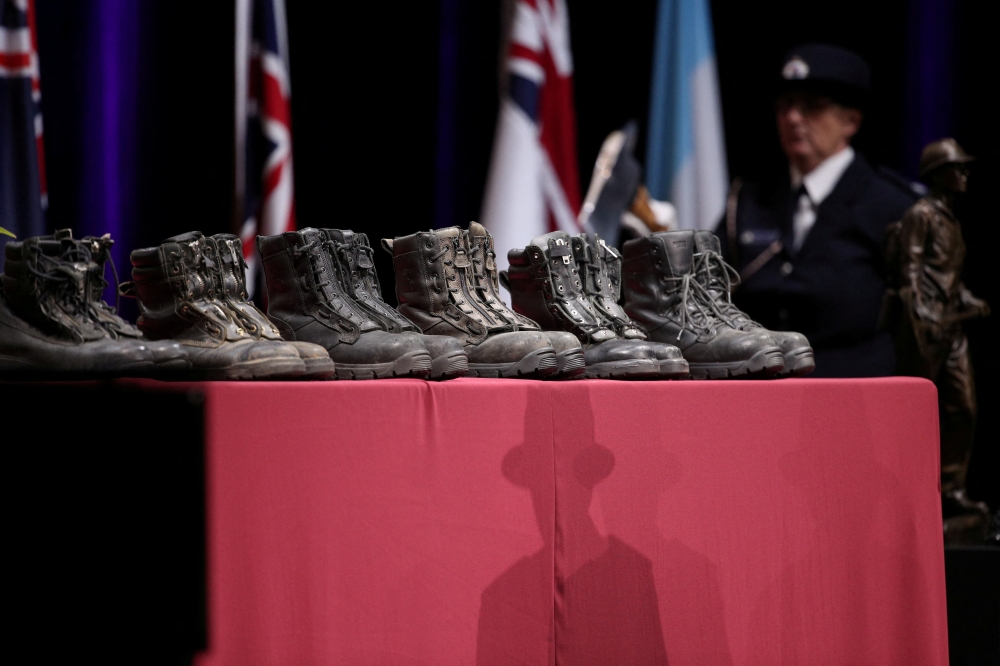 Boots honouring the firefighters killed in the Australian bushfires are seen at a state memorial at Qudos Bank Arena in Sydney, New South Wales, Australia, February 23, 2020. REUTERS/Loren Elliott/File Photo