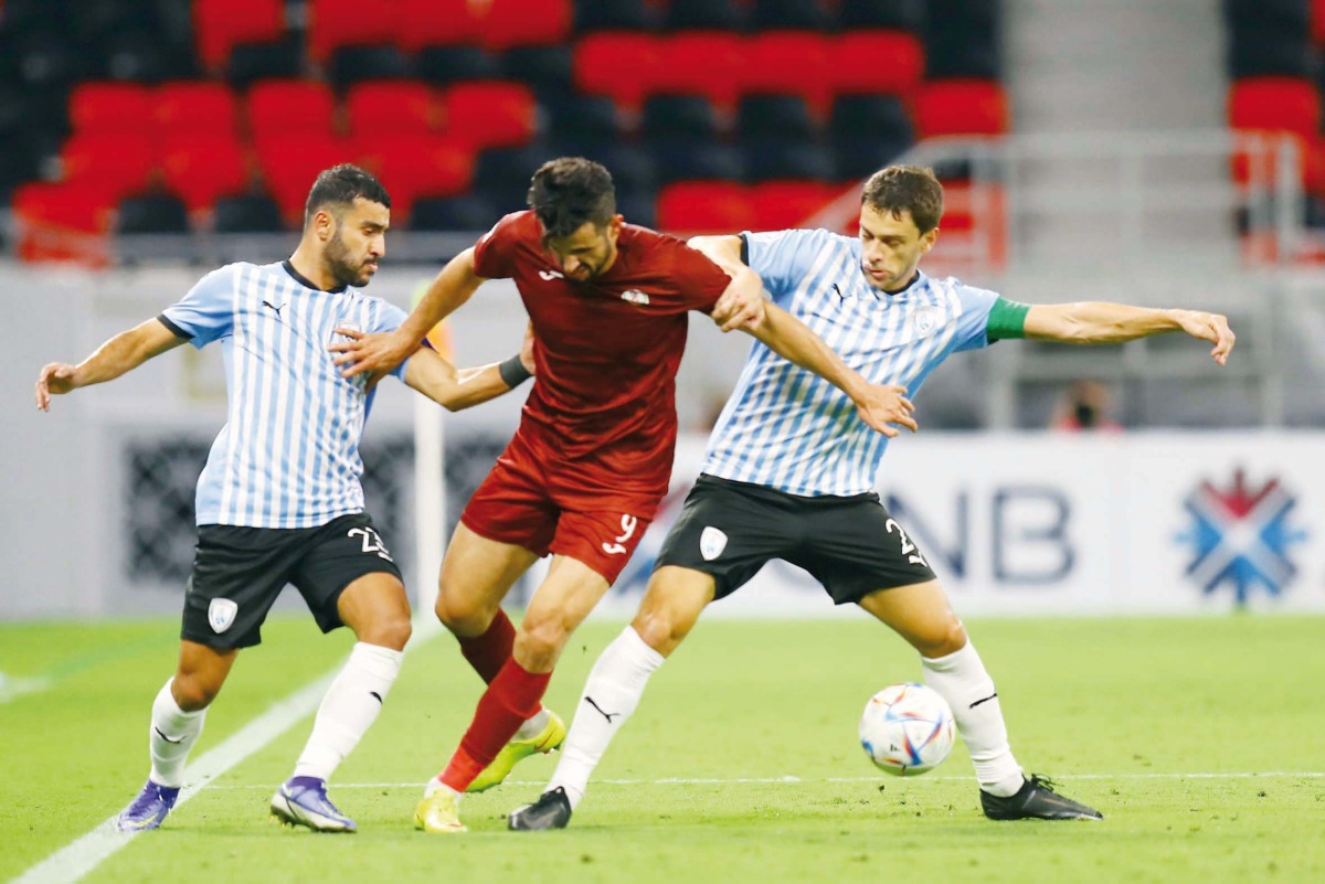 Al Markhiya's Ayman Hussein vies for the ball with Al Wakrah players during yesterday's match. Pic: Mohamed Farag