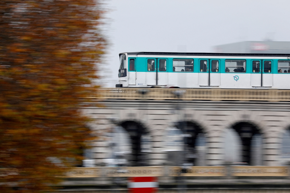 An elevated metro (or subway), operated by the Paris transport network (RATP), passes over a bridge in Paris, France, December 3, 2019. REUTERS/Charles Platiau/File Photo