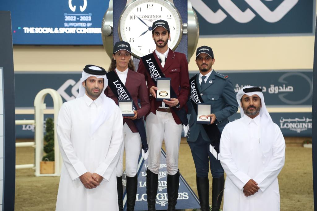 Sheikh Ahmed bin Noah Al Thani, Member, Higher Organising Committee Longines Hathab Sixth Edition, and Faisal bin Abdulhadi Al Marri, Assistant Tournament Director, with the winners of the Big Tour class of Longines Hathab opening round at the Qatar Equestrian Federation’s Indoor Arena yesterday.