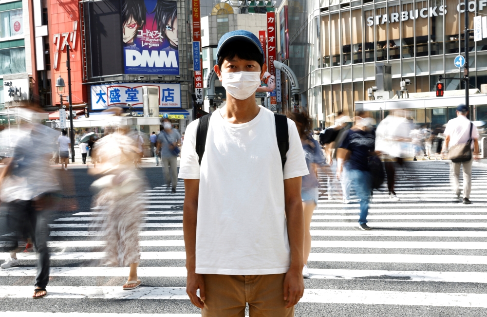 Shoji Morimoto who charges 10,000 yen ($71.30) an hour to accompany clients and simply exist as a companion, poses at Shibuya crossing in Tokyo, Japan August 31, 2022. REUTERS/Kim Kyung-Hoon