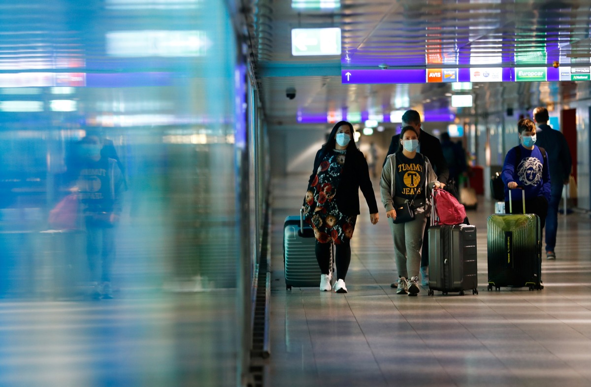 FILE PHOTO: Passengers walk through a terminal at Frankfurt Airport, as the spread of the coronavirus disease (COVID-19) continues in Frankfurt, Germany, April 1, 2021. REUTERS/Ralph Orlowski
