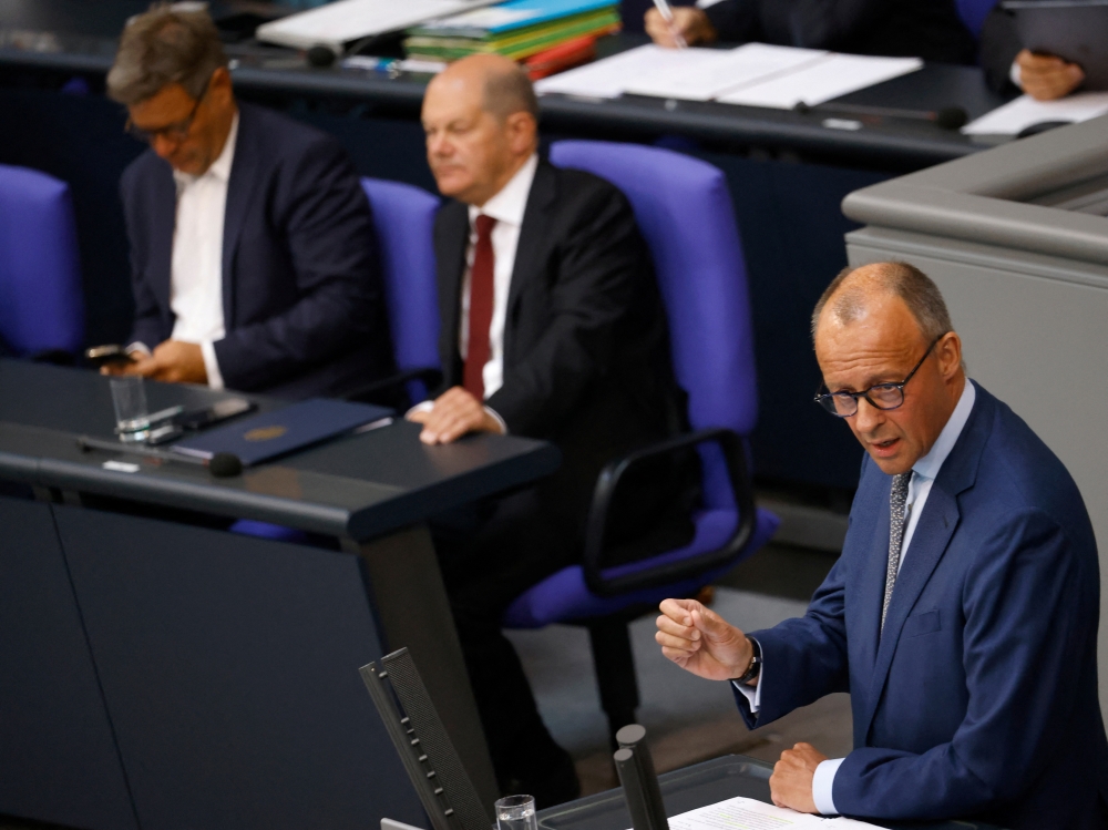 German Chancellor Olaf Scholz and Economy and Climate Minister Robert Habeck listen as Germany's Christian Democratic Union (CDU) party leader Friedrich Merz speaks during the budget debate in the lower house of parliament Bundestag in Berlin, Germany September 7, 2022. Reuters/Michele Tantussi