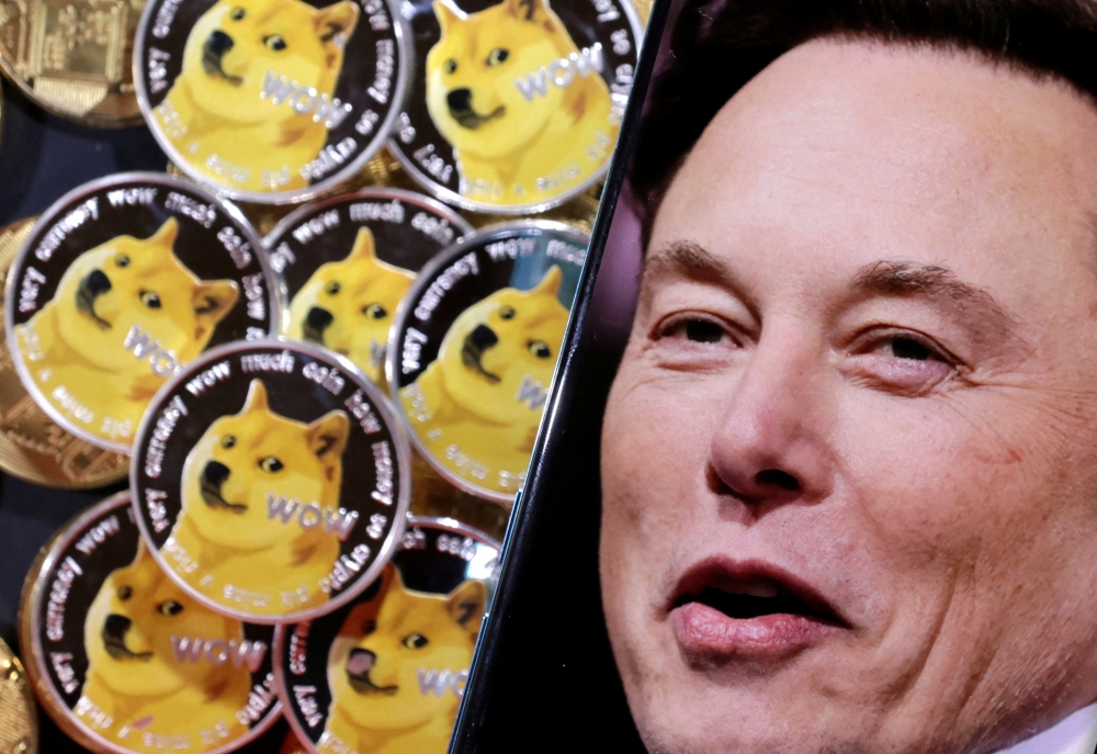 A photo of Elon Musk is displayed on a smartphone placed on representations of cryptocurrency Dogecoin in this illustration taken on June 16, 2022. REUTERS/Dado Ruvic/Illustration/File Photo