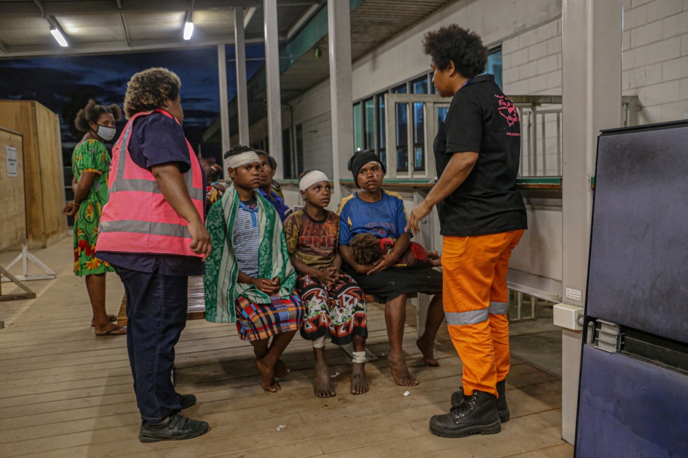 People are attended to while being evacuated following an earthquake, in Obura-Wonenara, Papua New Guinea, September 11, 2022. Manolos Aviation/Handout via Reuters