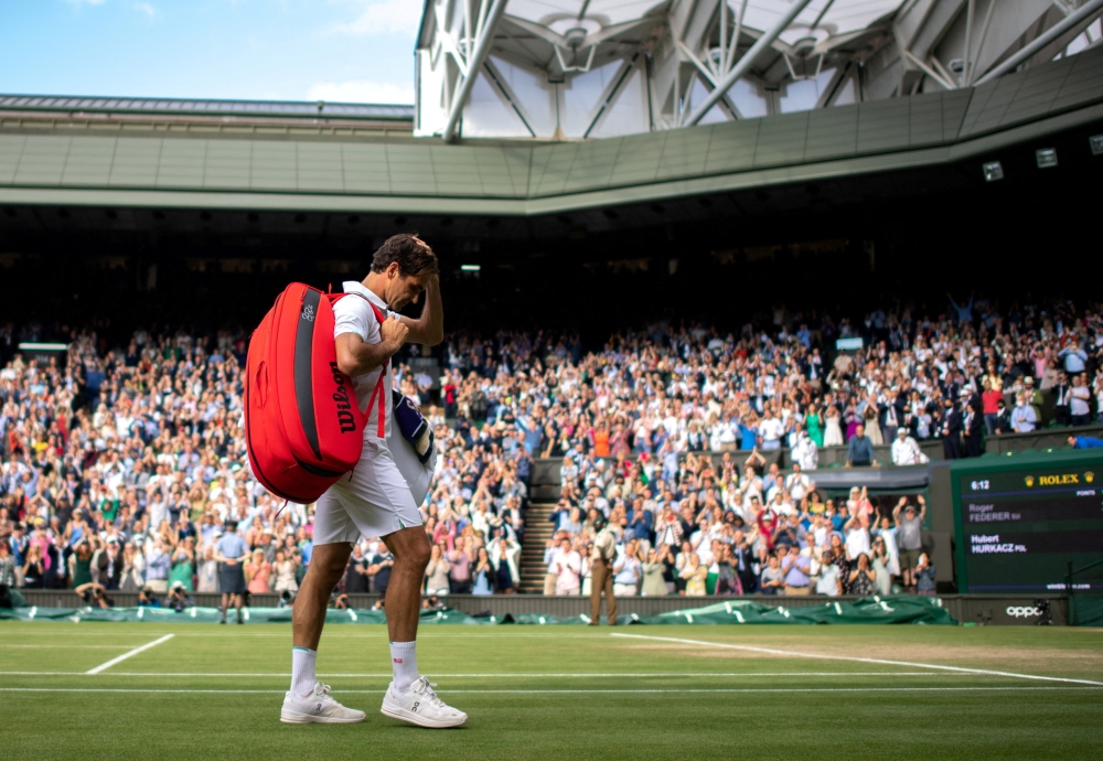 Switzerland's Roger Federer leaves Centre Court after losing his quarter final match against Poland's Hubert Hurkacz at the All England Lawn Tennis and Croquet Club in London on July 7, 2021.  File Photo / Reuters
