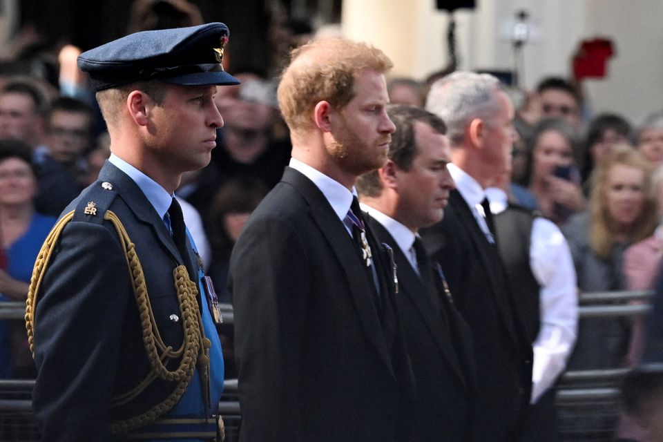 Britain's William, Prince of Wales and Prince Harry march during a procession where the coffin of Britain's Queen Elizabeth is transported from Buckingham Palace to the Houses of Parliament for her lying in state, in London, Britain, September 14, 2022. REUTERS/Clodagh Kilcoyne/File Photo

