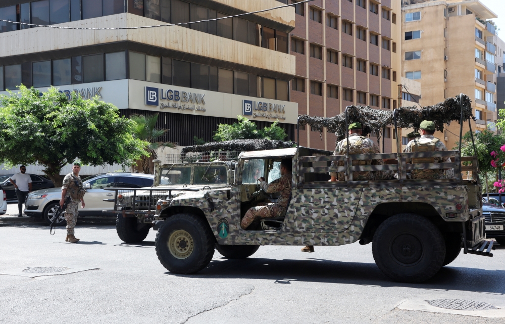 Lebanese army soldiers deploy outside an LGB Bank branch, where an armed man entered the branch seeking access to his own savings, according to a bank employee, in Ramlet al-Bayda area in Beirut, Lebanon, on September 16, 2022. (REUTERS/Mohamed Azakir)