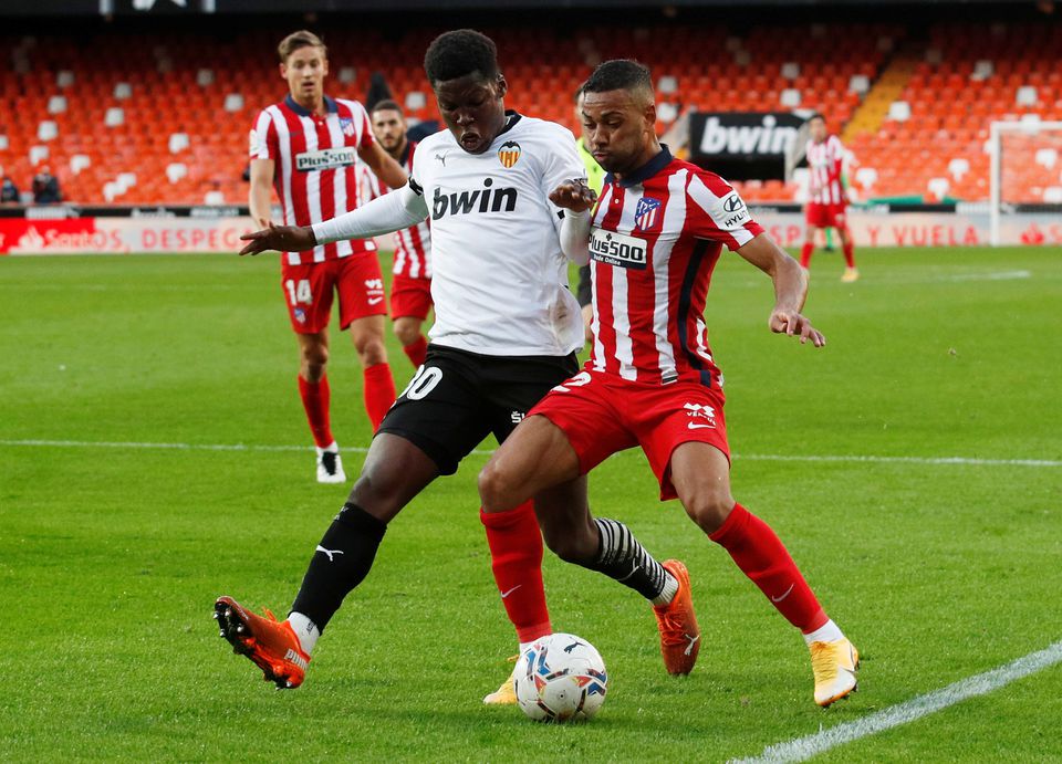 File Photo: Valencia's Yunus Musah in action with Atletico Madrid's Renan Lodi. (REUTERS/Albert Gea)