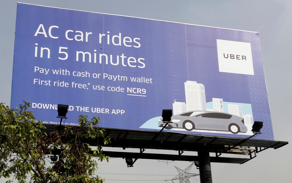 A billboard of ride-hailing service Uber is pictured on a highway in New Delhi, India, April 19, 2016. REUTERS/Anindito Mukherjee/File Photo