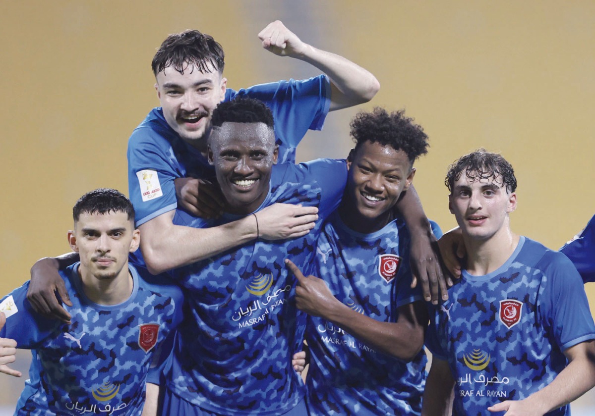 Al Duhail's Michael Olunga (centre) celebrates with team-mates after scoring a hat-trick against Al Markhiya, yesterday.