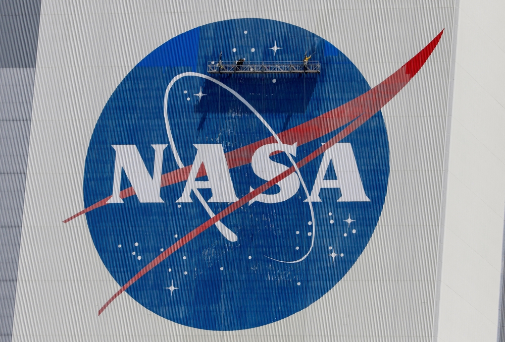 Workers pressure wash the logo of NASA on the Vehicle Assembly Building at the Kennedy Space Center in Cape Canaveral, Florida, US, on May 19, 2020. File Photo / Reuters
