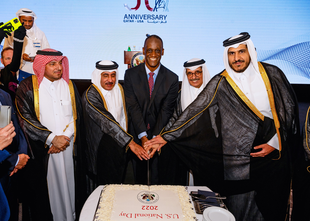 Ambassador of US to Qatar H E Timmy Davis (centre), Minister of Transport H E Jassim bin Saif Al Sulaiti (second left), Minister of Commerce and Industry H E Sheikh Mohammed bin Hamad bin Qassim Al Abdullah Al Thani (right), Minister of State H E Dr. Hamad bin Abdulaziz Al Kuwari (second right), and Director of Protocol Department at the Ministry of Foreign Affairs H E Ambassador Ibrahim Yousef Fakhroo (left) cutting the ceremonial cake during US National Day celebrations held at Le Royal Méridien Doha, yesterday.