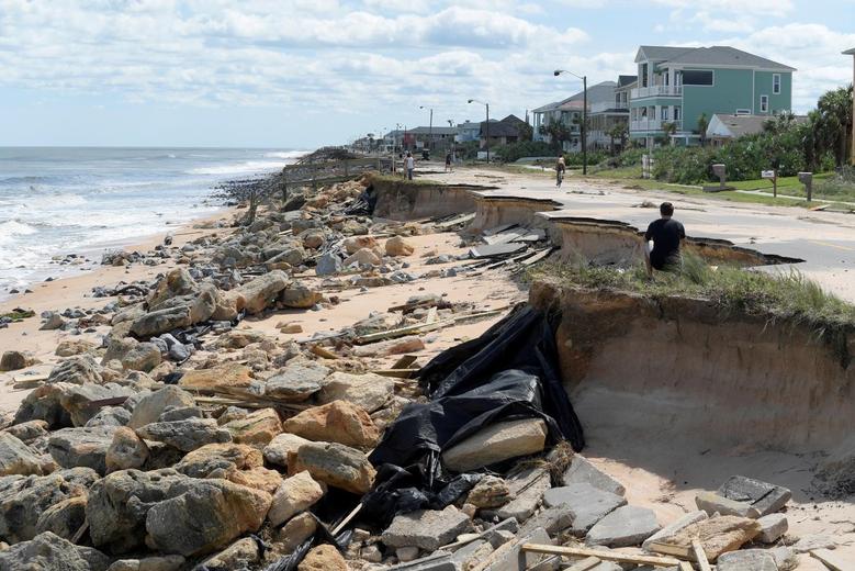 Onlookers view a washed out portion of State Highway A1A in the aftermath of Hurricane Matthew in Flagler Beach, Florida, on October 8, 2016.   File Photo/ Reuters
