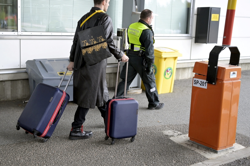 Ivan, 23, of Russia is led to an interrogation at the Vaalimaa border check point in Virolahti, Finland, on September 25, 2022. Ivan who arrived in Finland without a visa wants to apply for asylum. Jussi Nukari/Lehtikuva/via REUTERS